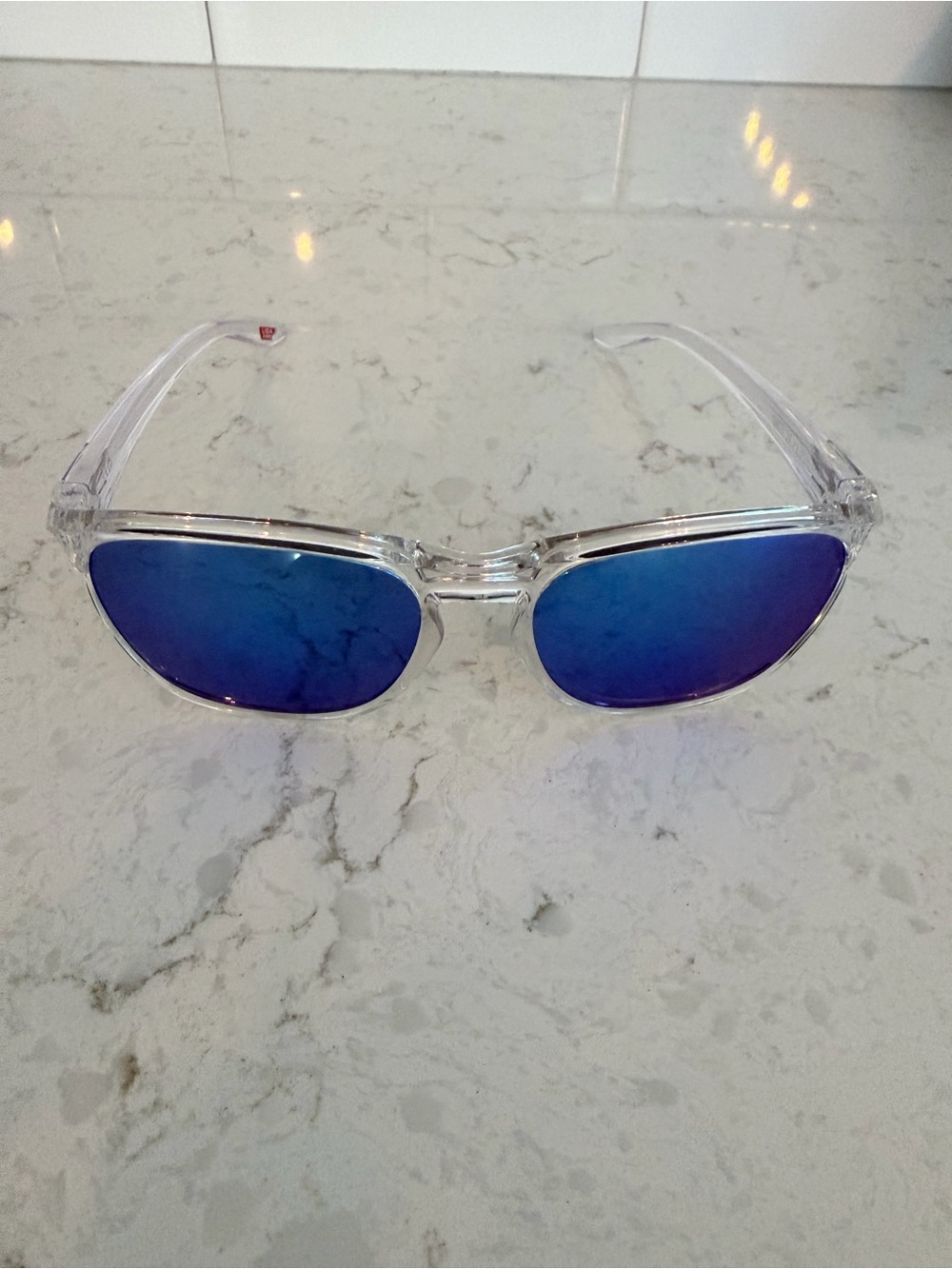 Oakley Clear Frame Sunglasses with Blue Mirrored Lenses